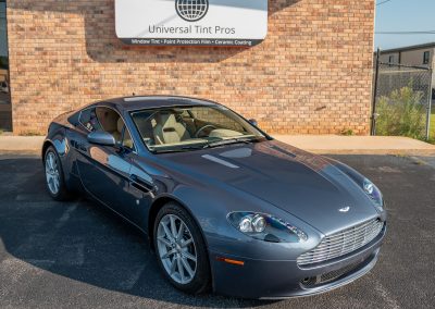 front end of blue gray aston martin